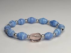 a blue bracelet with silver beads and a beaded clasp