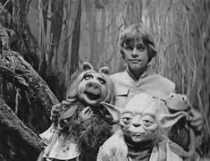 an old black and white photo of two people with yoda and baby yoda