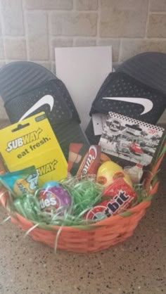 a basket filled with assorted items sitting on top of a counter next to a pair of flip flops