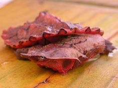 two pieces of food sitting on top of a wooden table