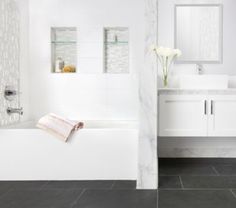 a white bathroom with two sinks and a bathtub