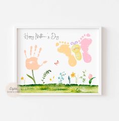 a card with two hand prints on it and flowers in the foreground that says, happy mother's day