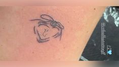 a small tattoo on the back of a woman's left arm with a rabbit head