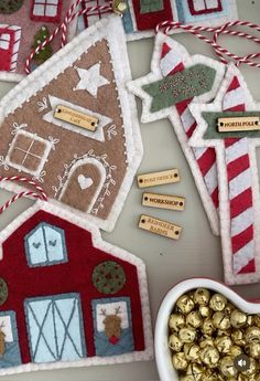 some ornaments are on a table next to a bowl of chocolates and candy canes