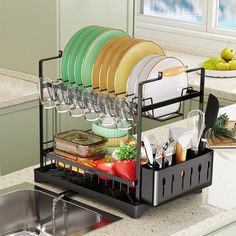 the dish rack is filled with dishes and utensils