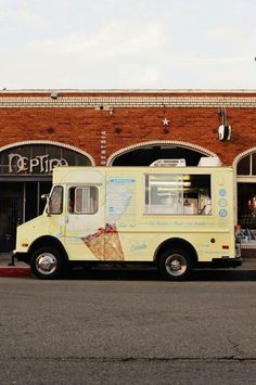 an ice cream truck parked in front of a building