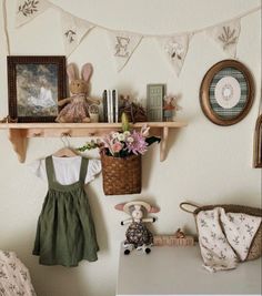 there is a shelf above the bed with pictures on it and flowers in a basket