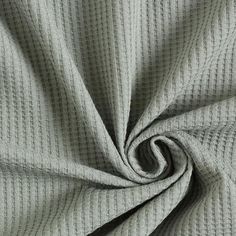 a close up shot of the texture of a grey fabric with small squares on it