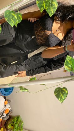 a woman standing in front of a cake with green leaves on it's sides