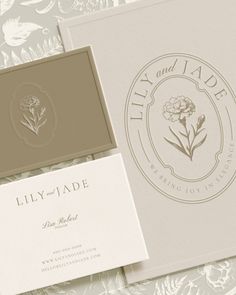 the logo and business cards are laid out on top of each other, including one for lily - vade