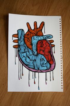 a drawing of a human heart with blood dripping down the side on a wooden table