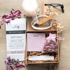 an assortment of items on a table including soap, tea bag and flowers with candles