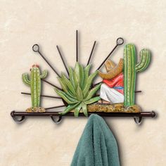 there is a towel and cactus on the shelf