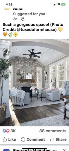 a living room filled with furniture and a fire place under a ceiling fan on top of a hard wood floor