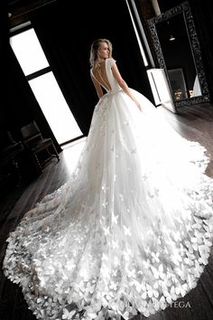 a woman in a white wedding dress standing on a wooden floor with butterflies all over it