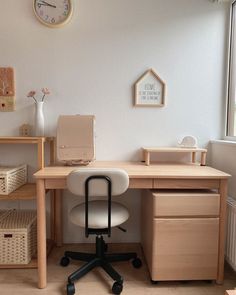 a desk with a chair and clock on the wall