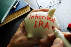 a person holding a piggy bank with the word inferried ira written on it