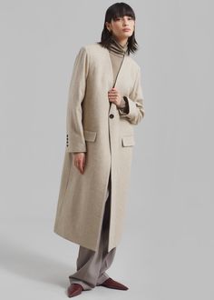 Color: Beige Midweight wool blend fabric Regular fit Collarless V neckline Button cuffs Front flap pockets Back slit 70% Wool 15% Polyester 15% Polyamide Lined Dry Clean Imported Beige Wool Coat, The Frankie Shop, Frankie Shop, V Neckline, Wool Coat, Wool Blend, Dry Clean, Sleeve Length, Wool