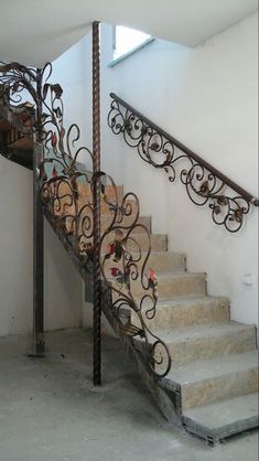 a stair case with wrought iron railing and handrail