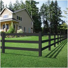 a large house behind a fence in the grass