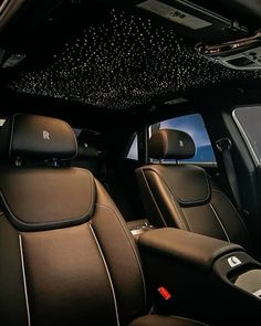 the interior of a car with black leather seats