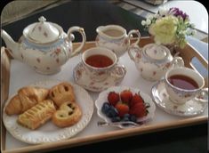 a tray with tea and pastries on it