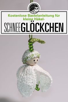 a small stuffed animal hanging from a green string with the words schnee glockchen on it