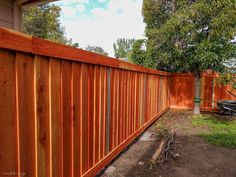 a wooden fence in front of a house