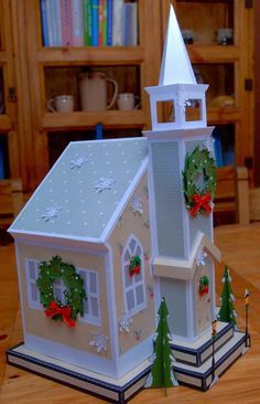 a paper model of a church with wreaths on it