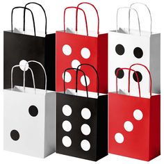 four different colored bags with black and white polka dots on them, each bag has a handle