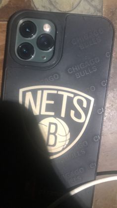 an iphone case with the new york nets logo on it, sitting on a table