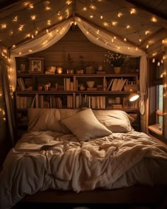 a bed that has some lights on the headboard and bookshelf behind it