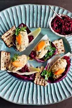 small appetizers are arranged on a blue plate