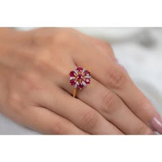 Round Cut Ruby Diamond Cocktail Engagement ring in 18K Gold which perfectly goes with your personality and also helps you to improve your energy and sensuality. Designed with seven round cut ruby and clustered diamonds that makes it a perfect fit to wear it on your wedding or style it with any of your basic outfit to give it a glam.  PRODUCT DETAILS :-  > Material - 18K Solid Yellow Gold > Gemstone - Ruby > Gemstone Weight - 2.4 ct > Gemstone pcs - 7 > Gemstone shape - Round  > Gemstone size - 4 Ruby Gold Ring Design For Women, Cocktail Gold Ring Designs, Flower Shaped Ruby Ring In Yellow Gold For Wedding, Flower-shaped Yellow Gold Ruby Ring For Wedding, Yellow Gold Ruby Ring For Wedding With Flower Shape, Elegant Ruby Flower Ring In Yellow Gold, Yellow Gold Flower Ruby Ring For Wedding, Flower Shaped Ruby Gemstone Rings, Wedding Ruby Cluster Ring With Brilliant Cut