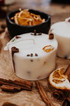 two soaps with cinnamon and anise on the table next to some cinnamon sticks