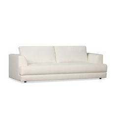 a white couch sitting on top of a white floor