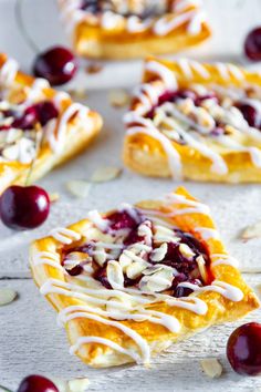 cranberry tarts with white chocolate drizzle and cherries on top