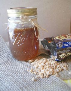 a jar filled with peanut butter and jelly next to a bag of krispy kreme