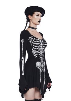 This mini dress has a stretchy knit construction, a skeleton bone graphic print on the front and sleeves, long sleeves with bell cuffs, and a handkerchief hem with lettuce trim. Goth Staples, Sable Ward, Bone Fairy, Goth Clothing, Windsor Smith, Costume Store, Pride Outfit, A Skeleton, Handkerchief Hem