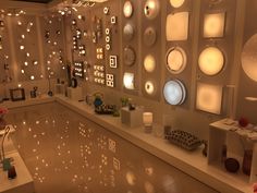 a room filled with lots of lights and plates on the wall