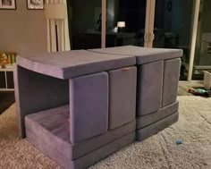 a large grey couch sitting on top of a white rug