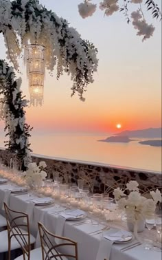 the table is set with white flowers and candles