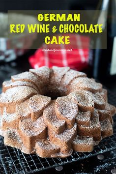 german red wine and chocolate cake with powdered sugar on the top, sitting on a cooling rack