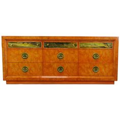 a wooden dresser with brass handles and drawers