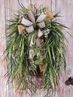 a wreath hanging on the side of a wooden door