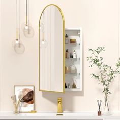 a bathroom vanity with a mirror, lights and vases on the shelf next to it