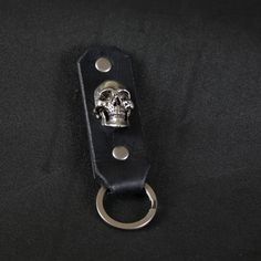 a key chain with a metal skull on it