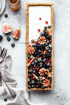 a fruit tart with berries, kiwis, and other fruits on it