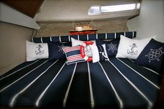 a bed with blue and white striped bedspread