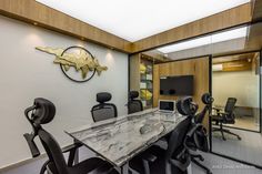 an office with marble table and black chairs